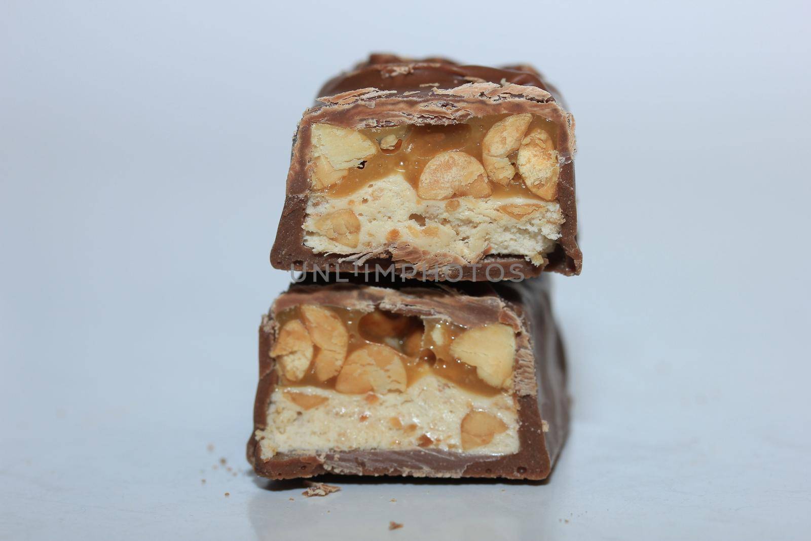 Chocolate candy bars in half on a white background