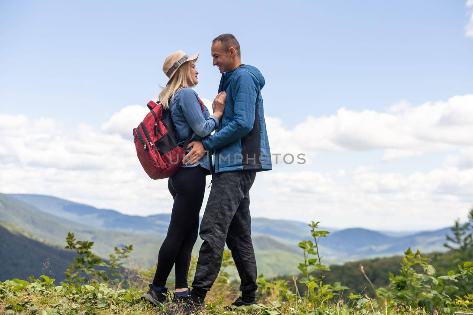 beautiful young couple enjoying nature at mountain.