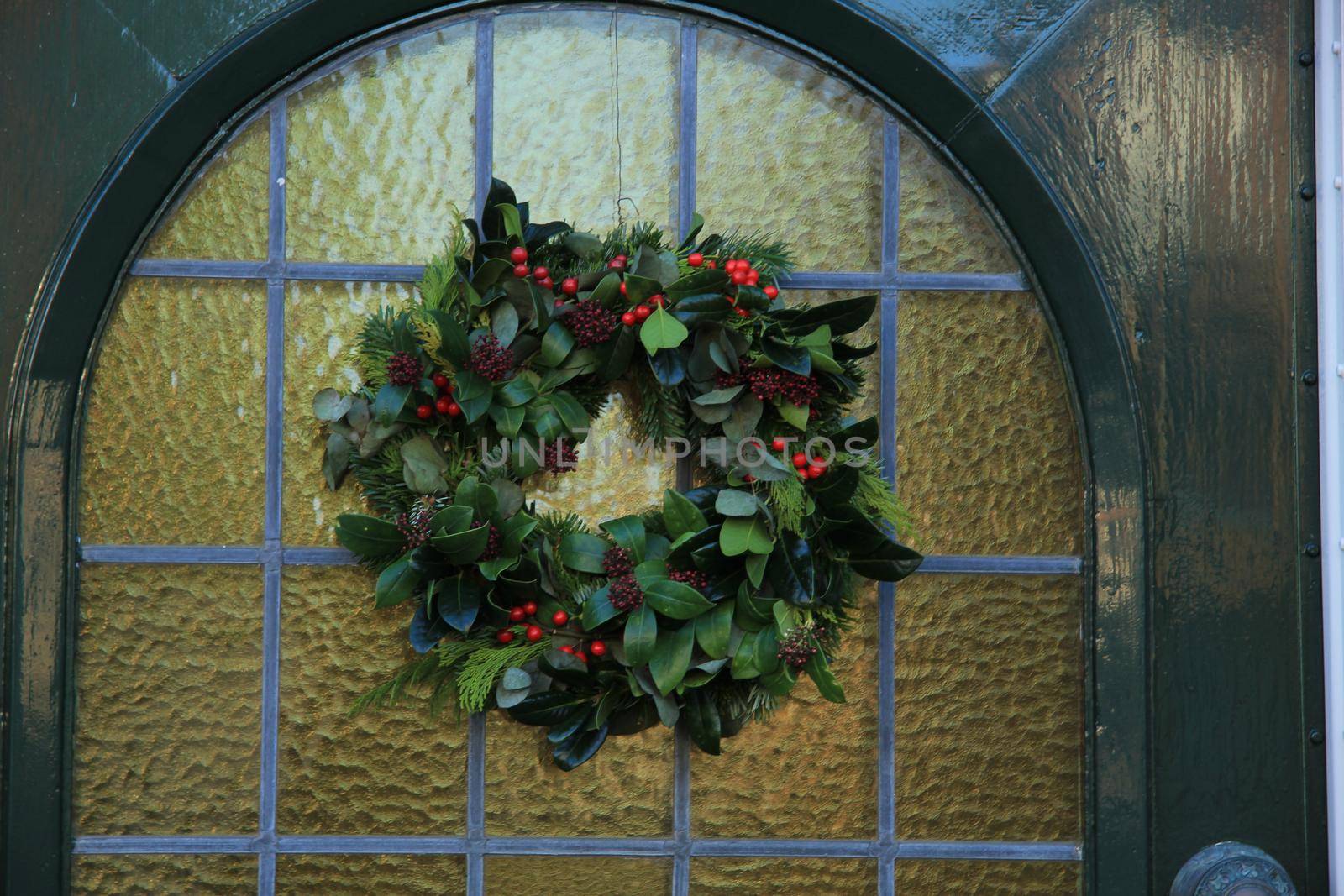 Classic christmas wreath with decorations on a door