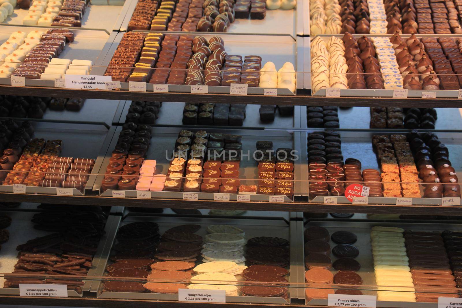 Luxurious Chocolates on display in a confectioner's shop (tags: price and product information in Dutch)