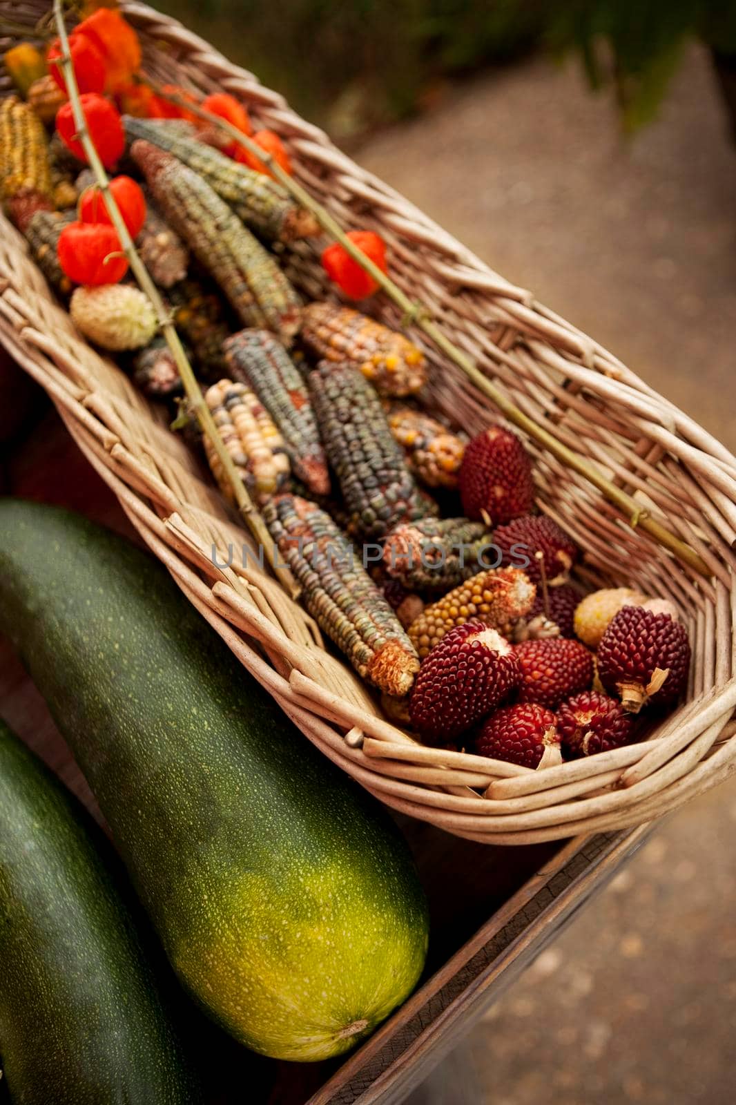 Zucchini, peppers, corn and arbutus berry on a market stall