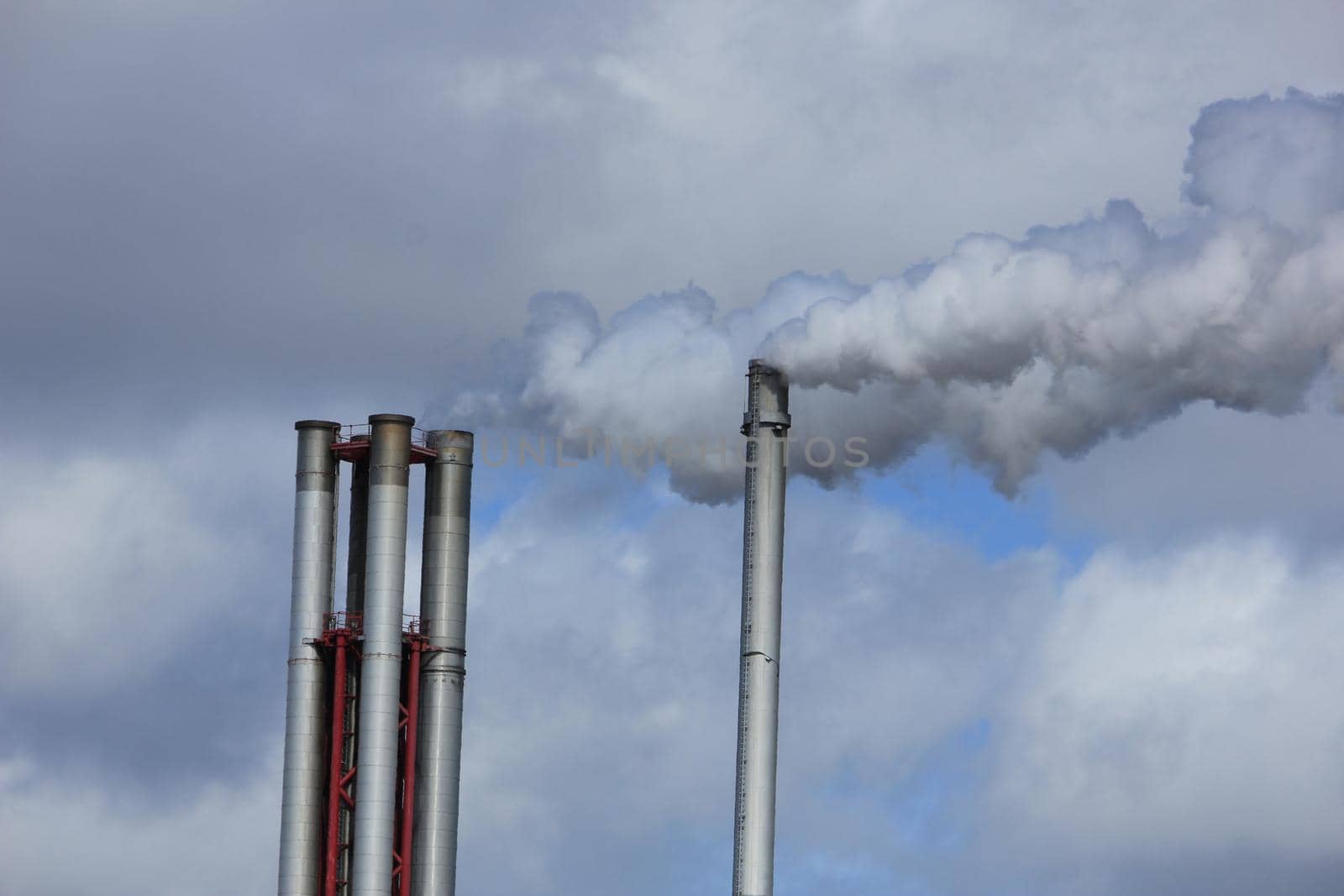 Chimneys and smokestacks of an industrial plant, Chemical industrial industry by studioportosabbia