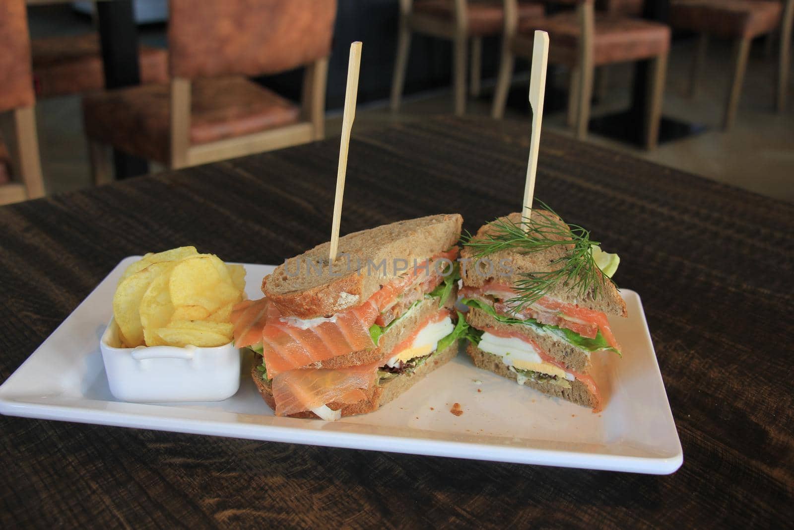 A fresh salmon sandwich: smoked salmon, lettuce, fresh dill and egg