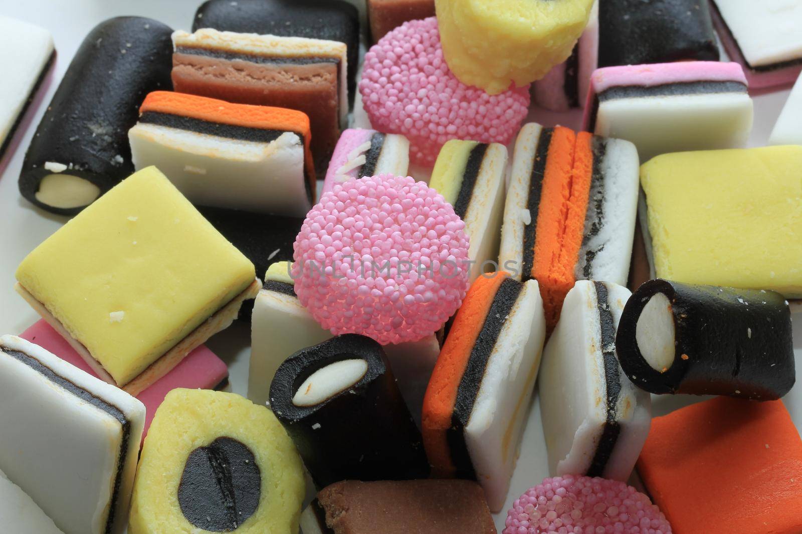 Pile of liquorice allsorts in different shapes, colors and sizes