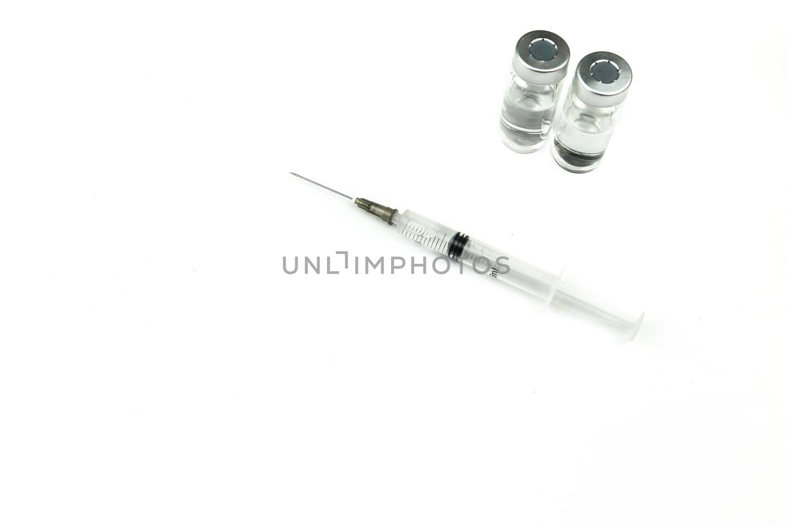 Vials and syringe filled with medicine by soniabonet