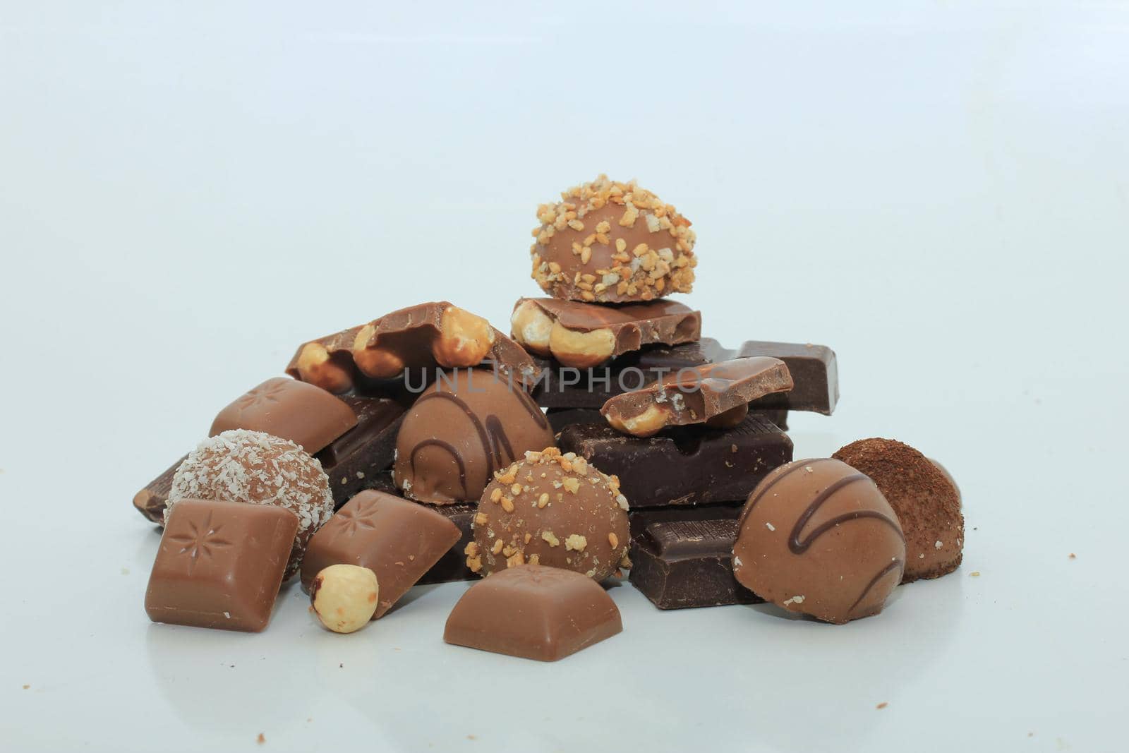 Different sorts of chocolates: bonbons and broken pieces of a chocolate bar