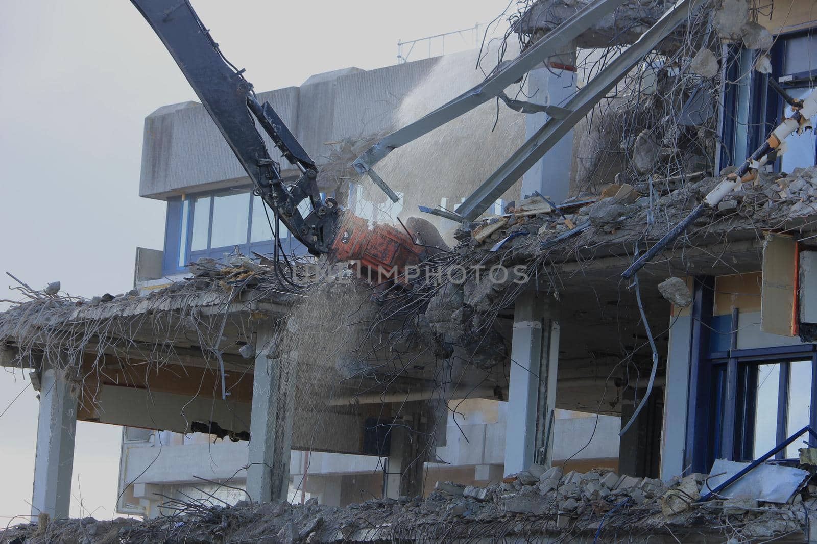 Demolishing a building with hydraulic crushers