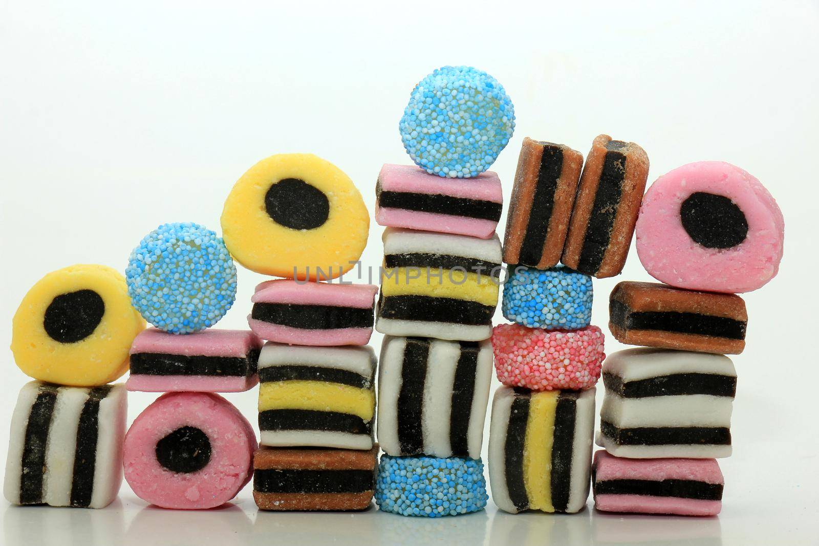 Stacked liquorice all sorts in different shapes, colors and sizes by studioportosabbia