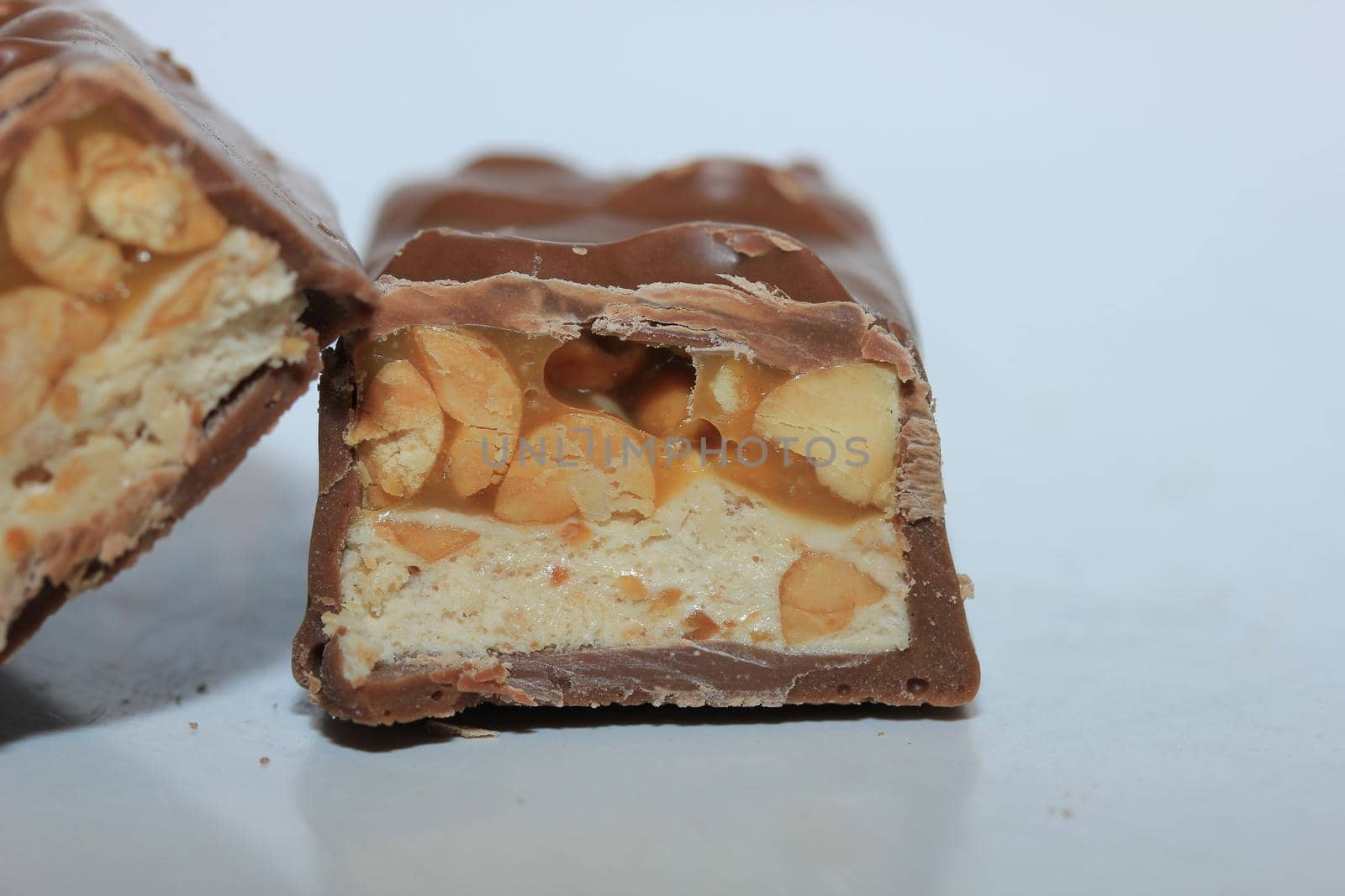 Chocolate candy bars in half on a white background