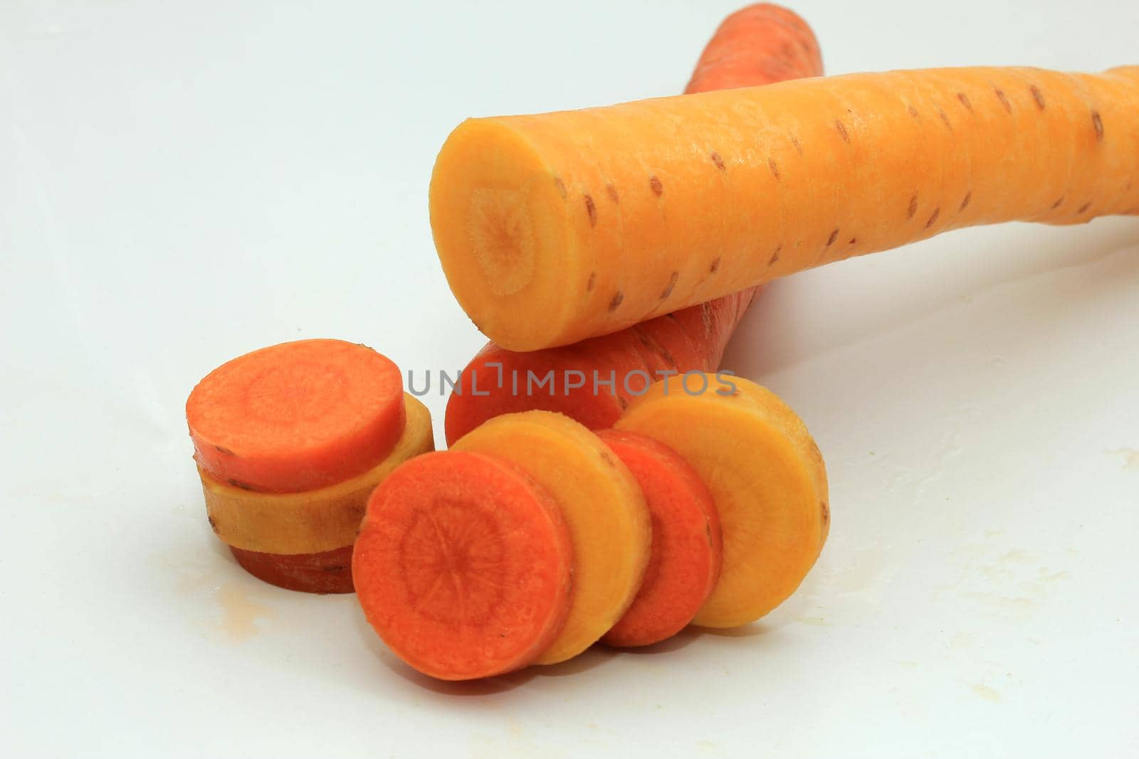 Fresh carrots, orange and yellow, cut in slices