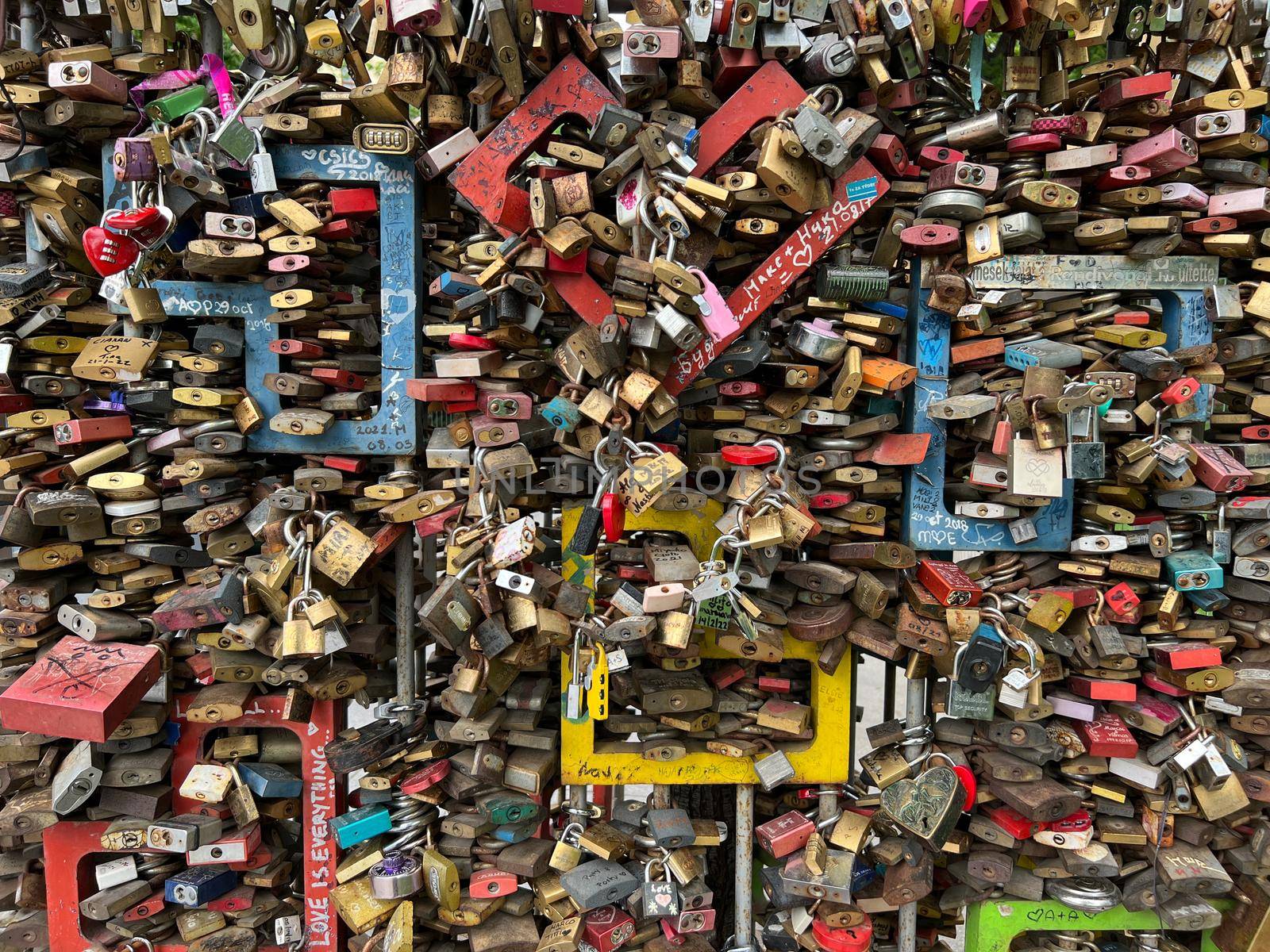 Colorful padlocks hang on a metal fence. Budapest, Hungary. High quality photo