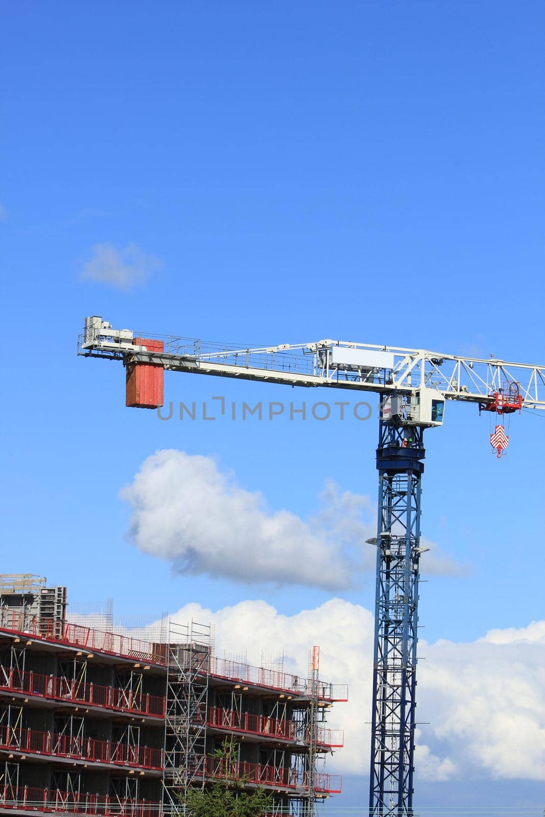 Tall construction crane at a construction site