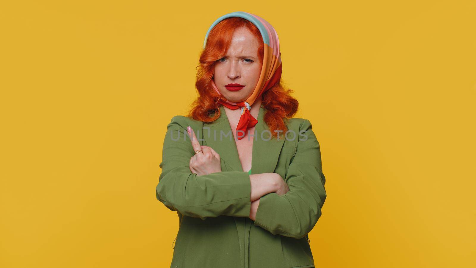 Aggressive Crazy Hooligan Redhead Young Woman Showing Around Her Middle Fingers Demonstrating Protest With Impolite Rude Gesture Of Disrespect Rejecting Communication. Ginger Girl On Yellow Background