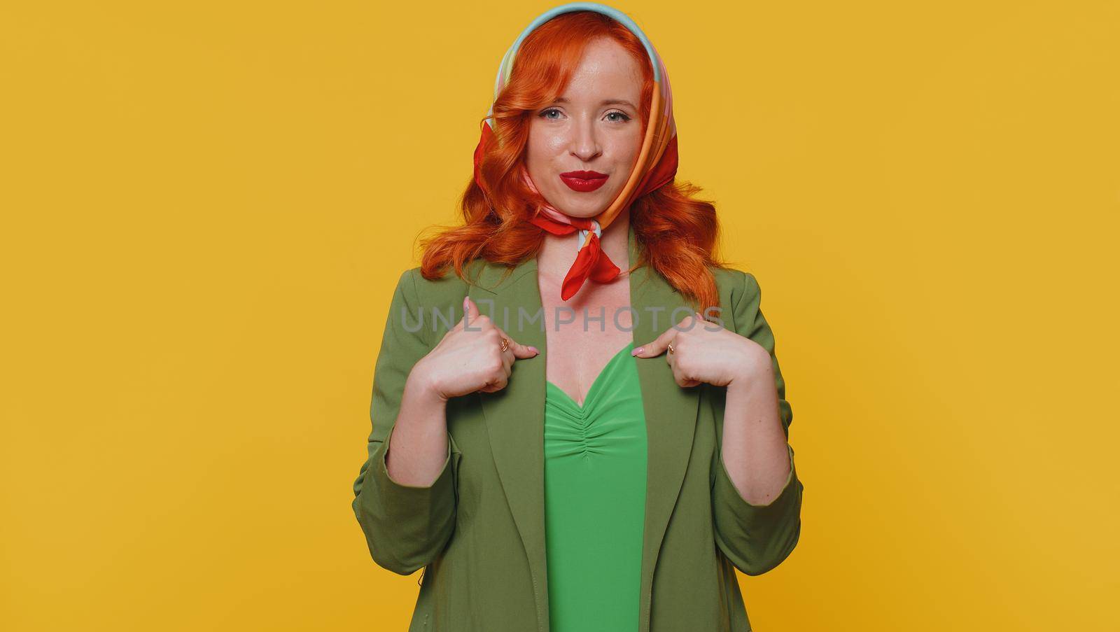 I am the best, choose me. Redhead young woman feeling very proud pointing herself, looking self-confident, overjoyed by success. Adult ginger girl indoors studio shot isolated on yellow background