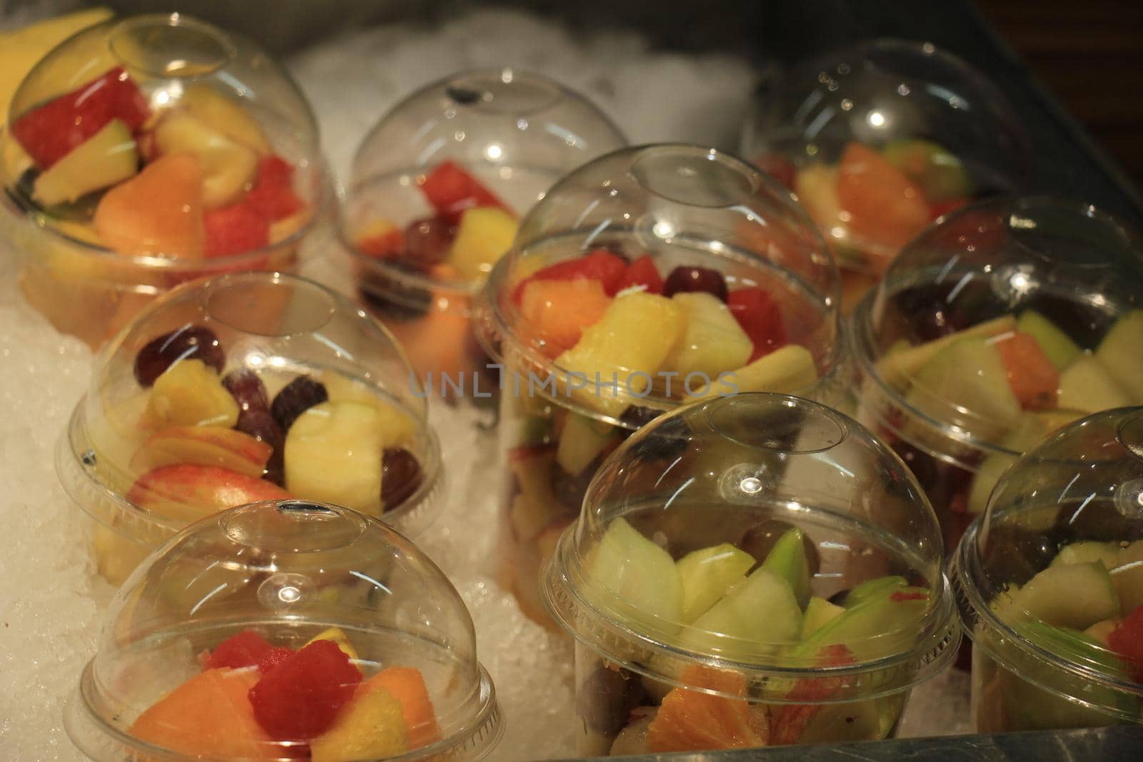 Fresh fruit on ice at a self service restaurant by studioportosabbia