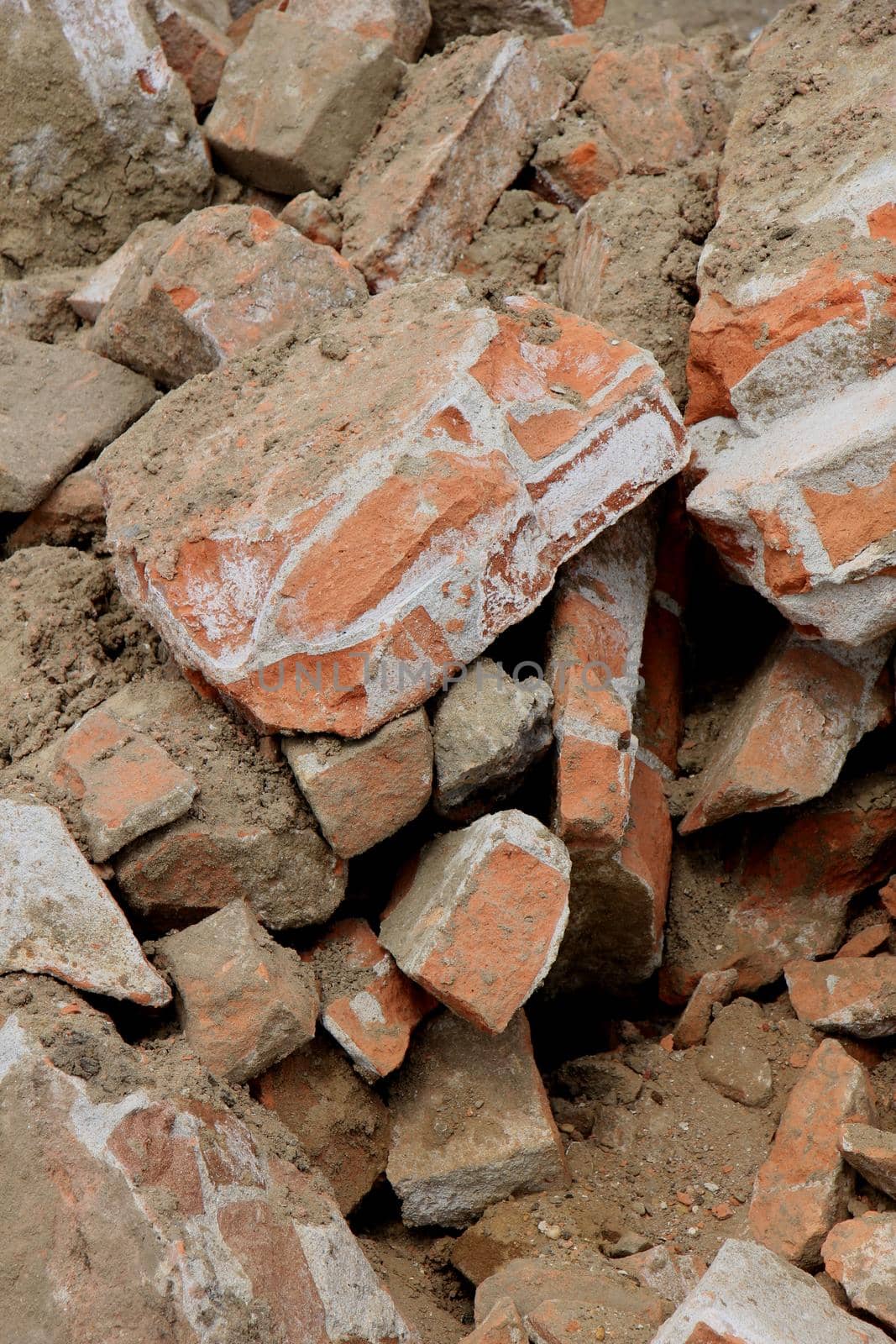 Pile of broken red bricks on construction site