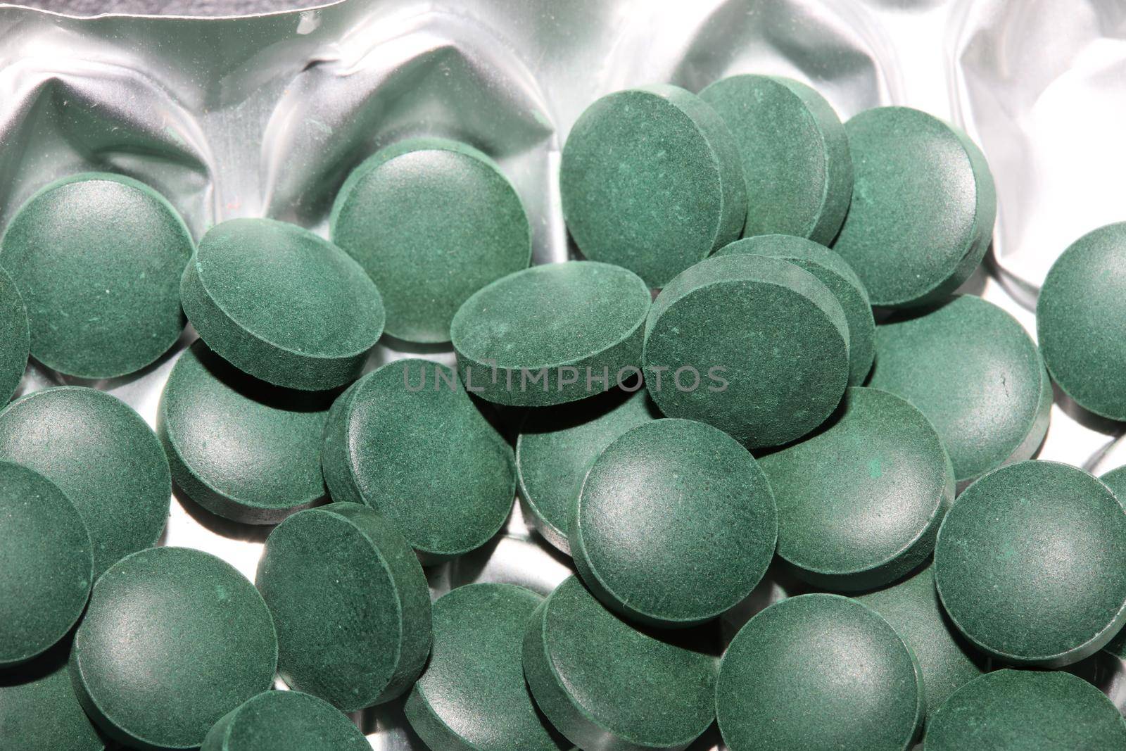 Medical green round vitamins spirulina platensis healthy super food close up background high quality big size prints