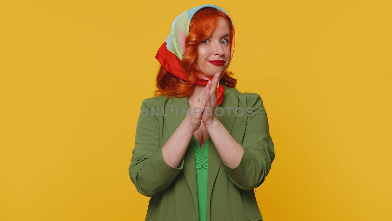 Great nice job. Cheerful positive happy woman in jacket showing thumbs up and nodding in approval, successful good work. Young stylish ginger girl on yellow studio background. People sincere emotions