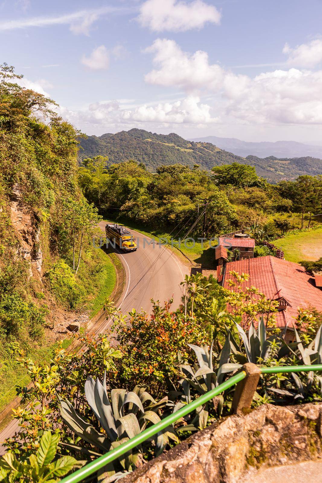 Vertical photo of a typical road in Jinotega, Nicaragua on a sunny day. An everyday landscape of Latin America.