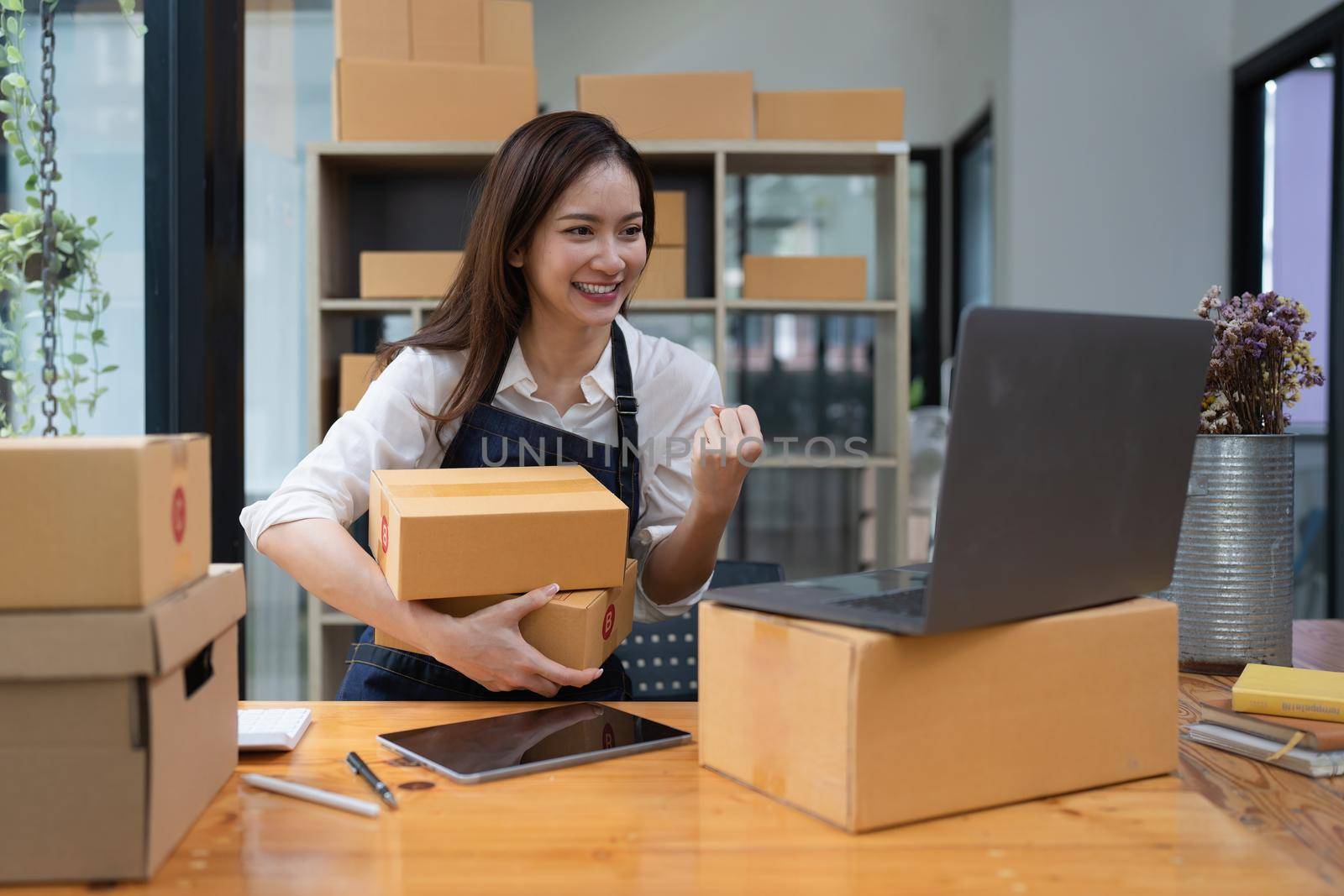 Attractive Asian entrepreneur business woman excited while order come.