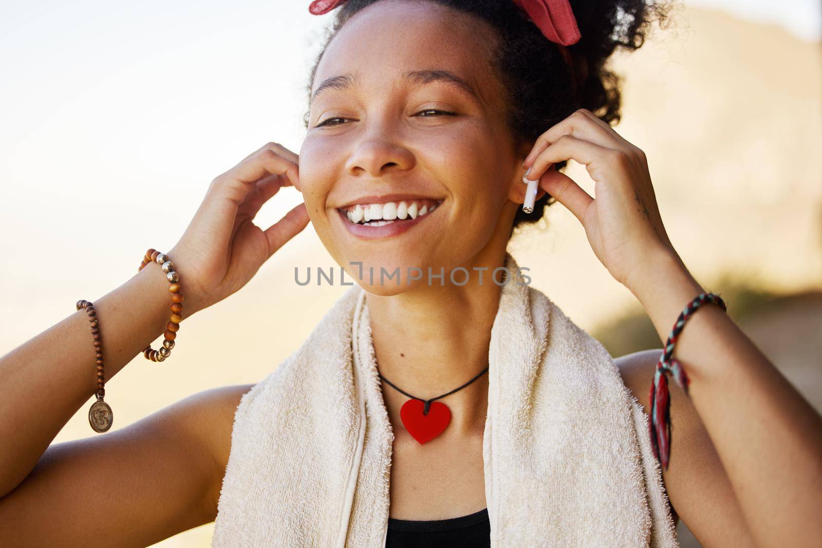 Music pumps my heart with joy. a young woman wearing earphones while out for a workout