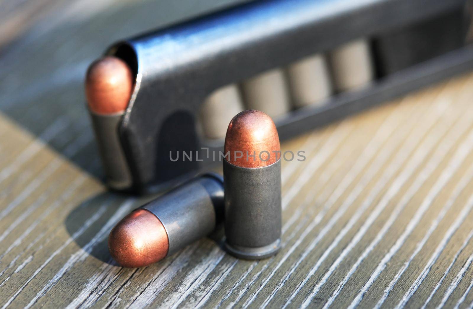 Pistol Cartridges On Wood by kvkirillov