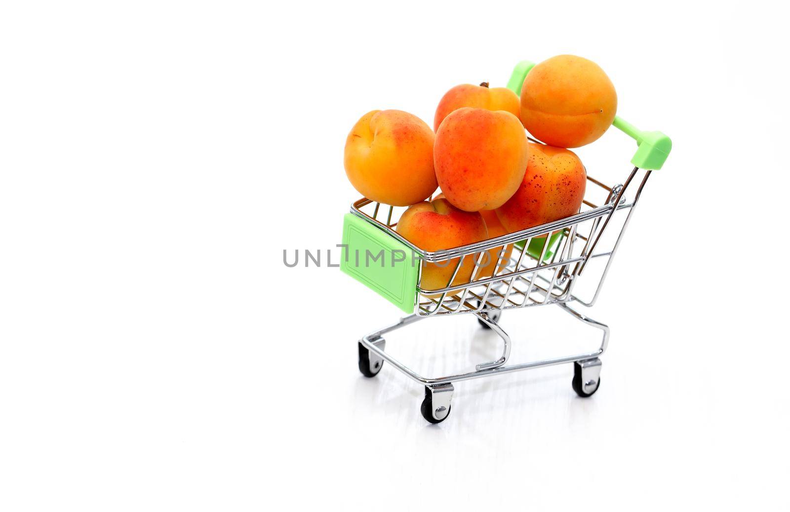 Healthy eating concept. Shopping cart with freshness apricots