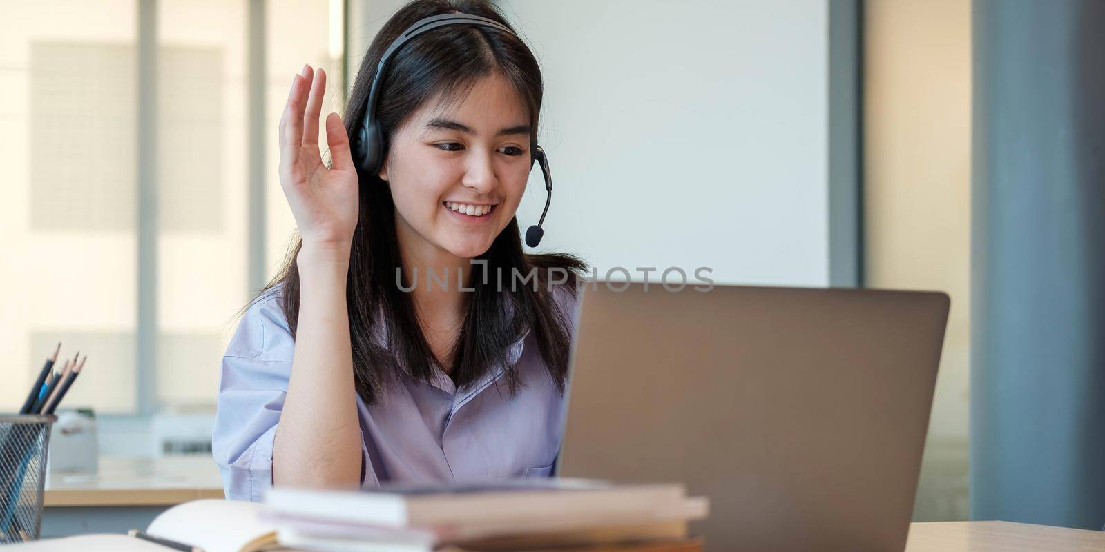 Homeschool Caucasian cute young girl student learning virtual internet online class from school teacher by remote meeting due to covid pandemic. Male teacher teaching math calculus by using whiteboard by wichayada