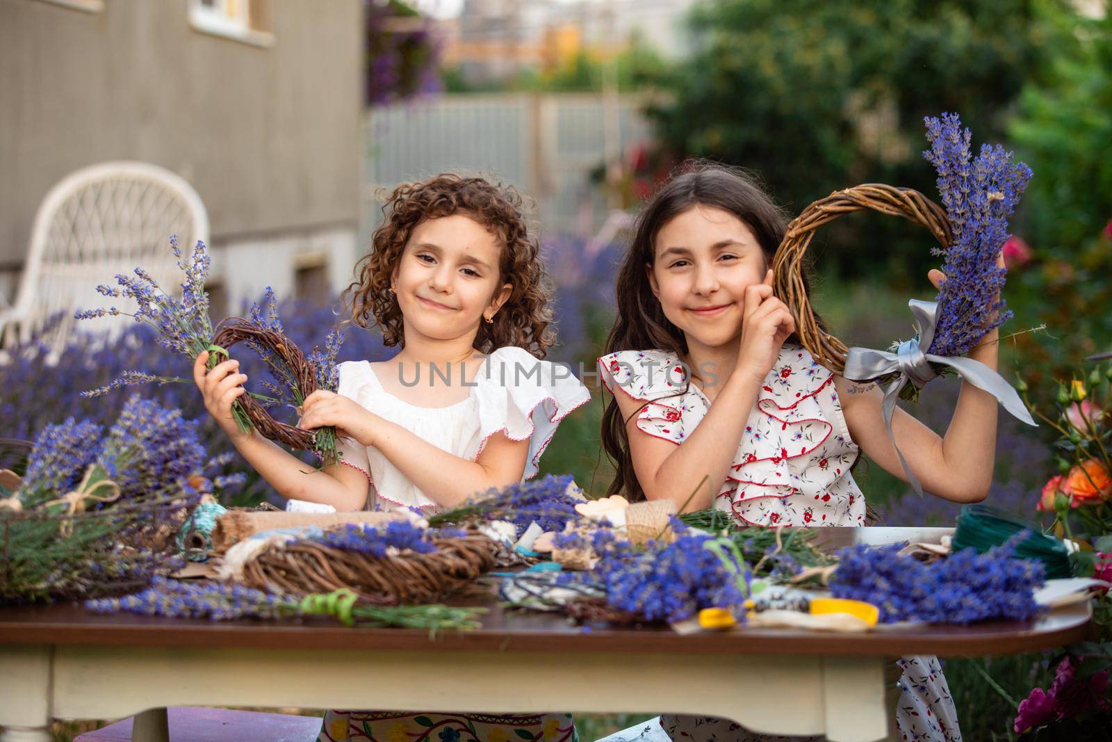 Girls make homemade lavender wreaths as a decor for home or present