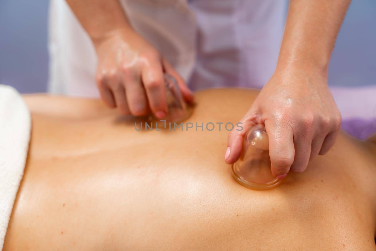 Facial massage. A woman is given a massage in a beauty salon. Close-up. by Matiunina