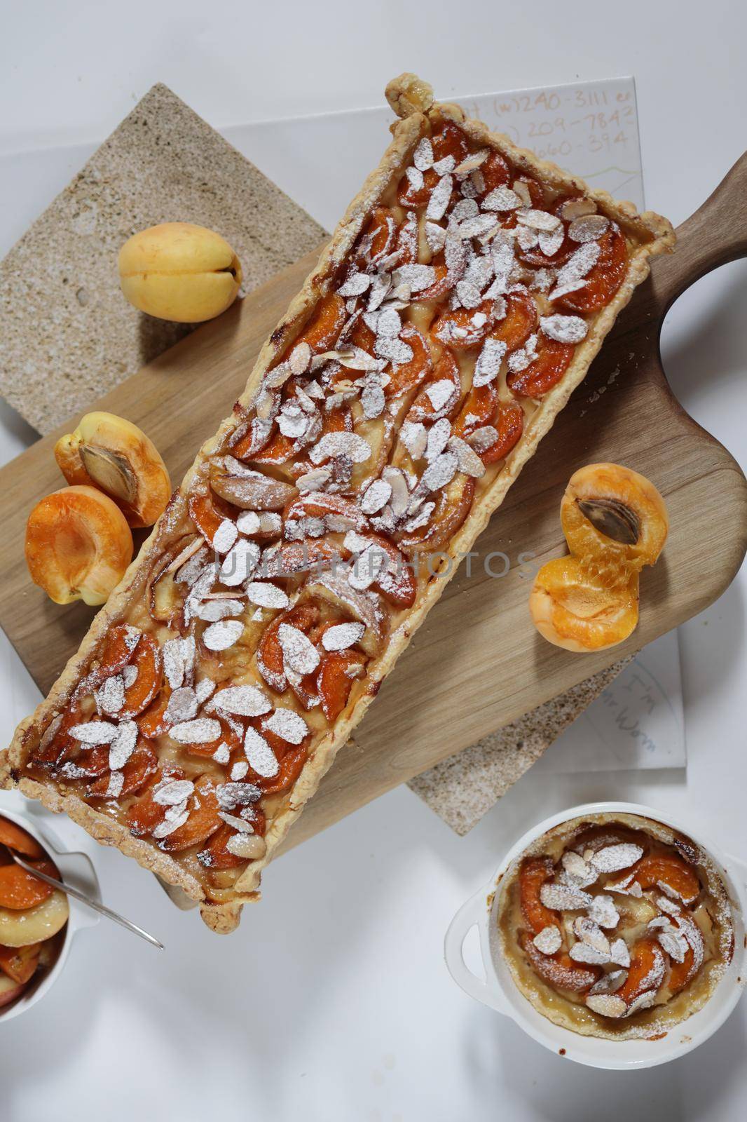 Homemade rectangular shortbread pie with apricots and peaches. White background