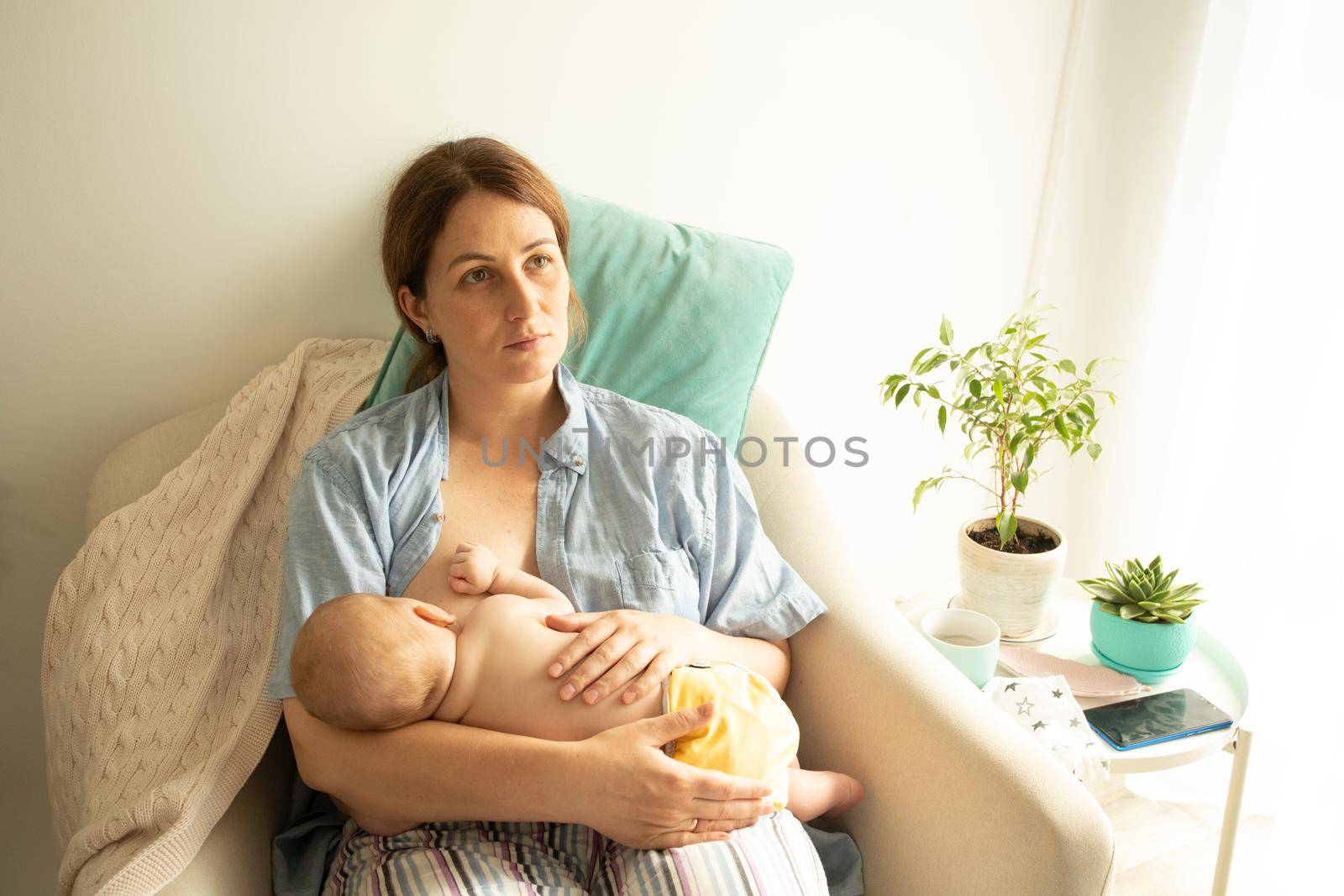 The young mom wants to breastfeed her newborn baby by oksix