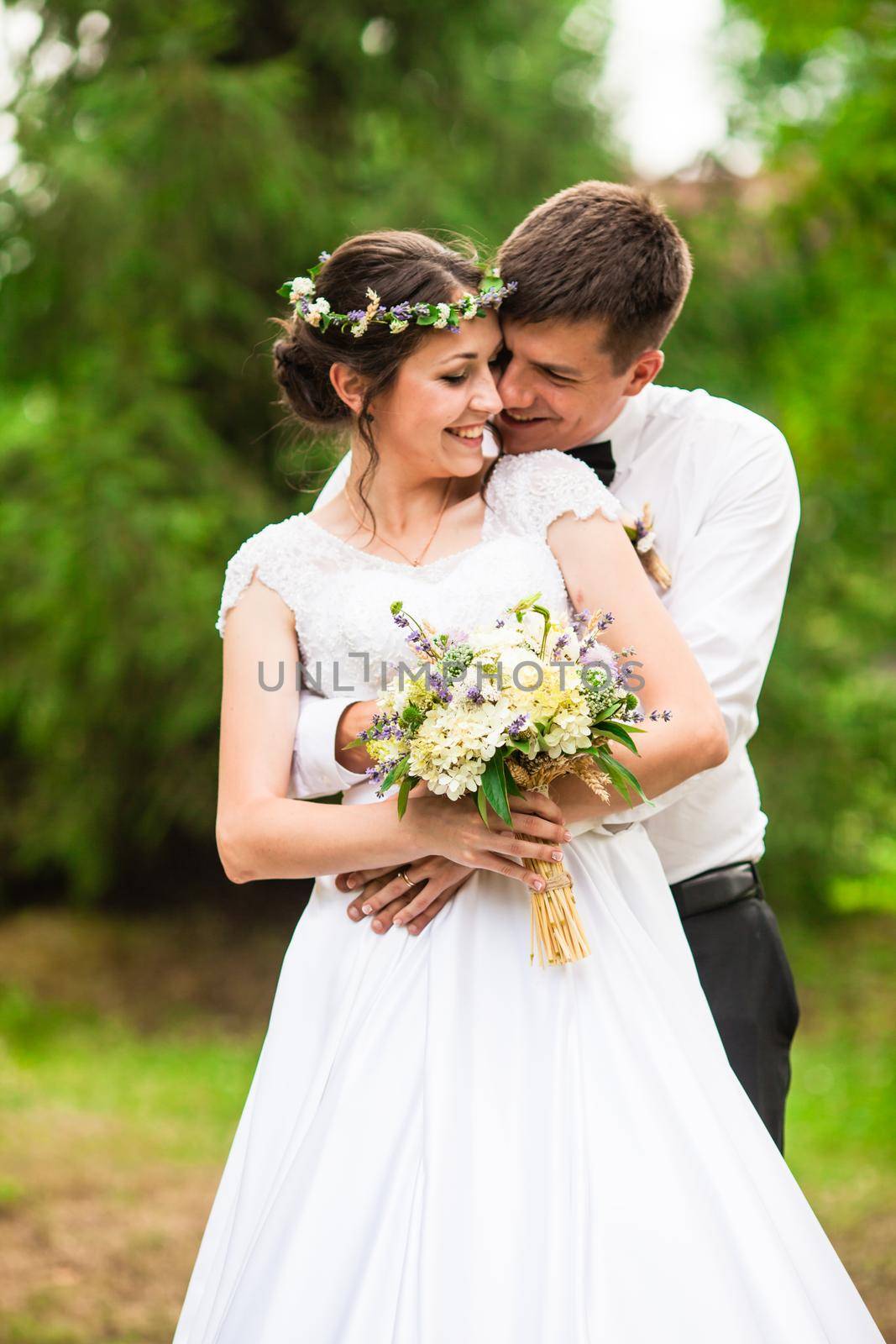 Happy bride and groom after wedding ceremony walking at the park and have photoshoot