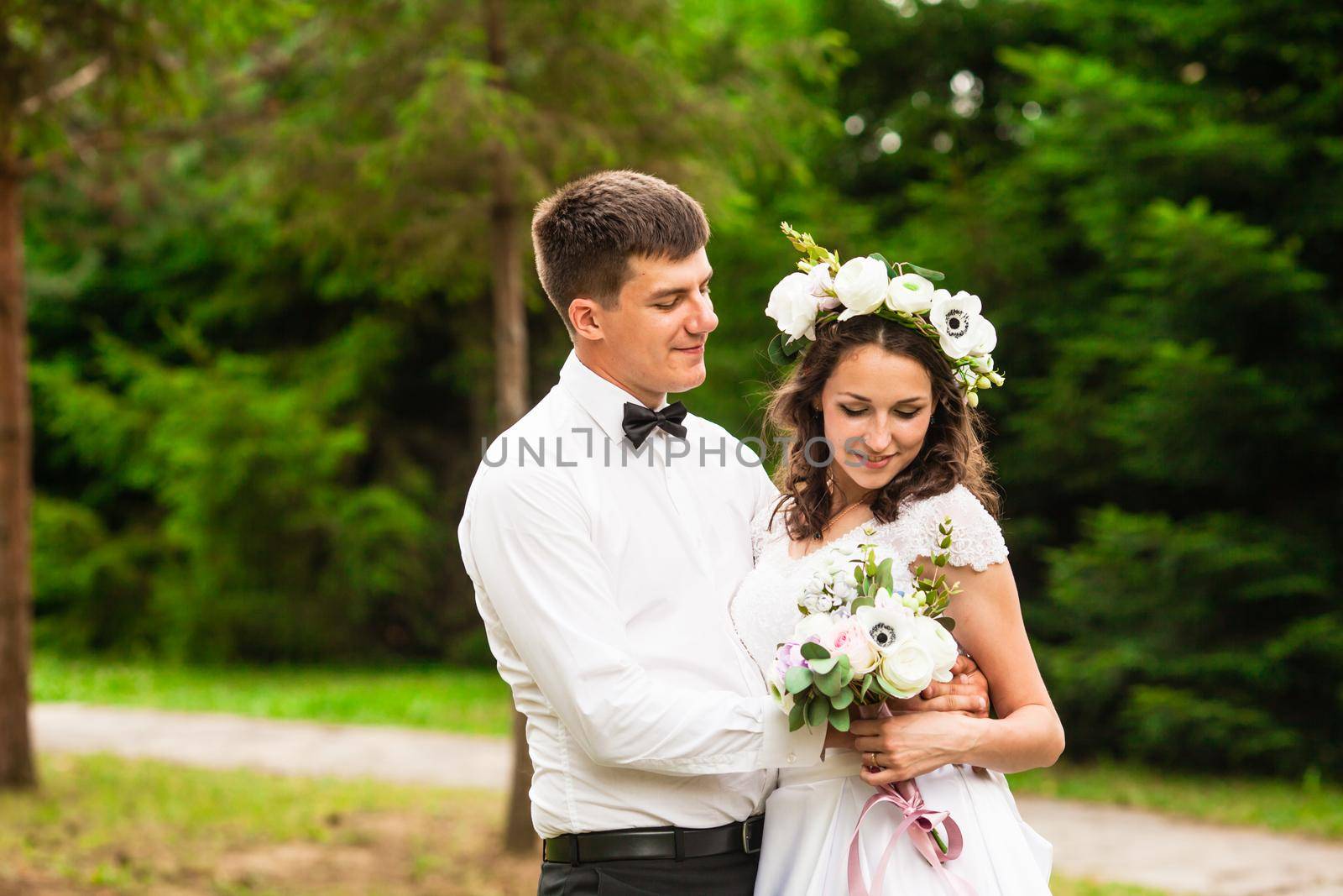 Happy bride and groom after wedding ceremony walking at the park and have photoshoot