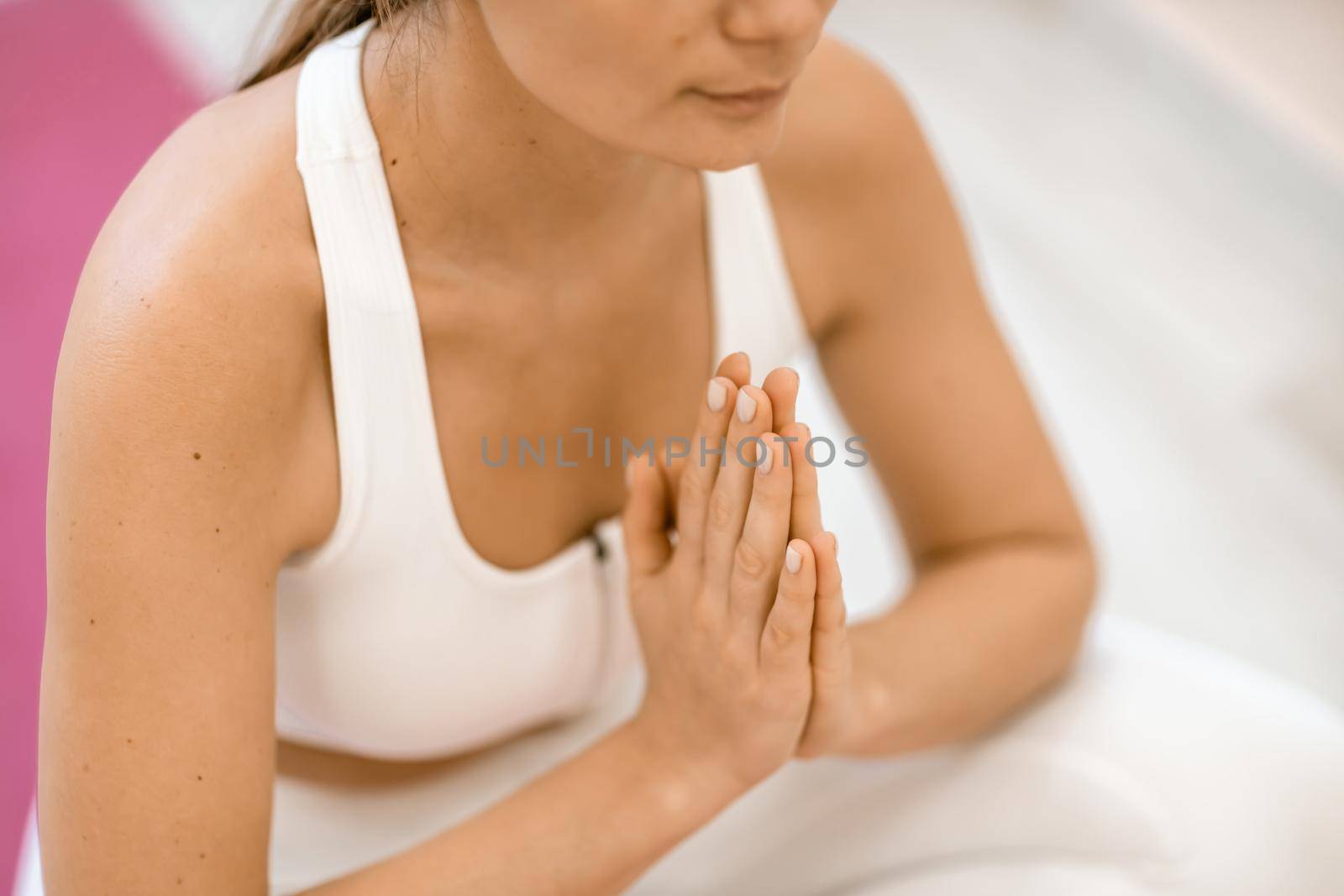 Girl does yoga. Young woman practices asanas on a beige one-ton background. by Matiunina