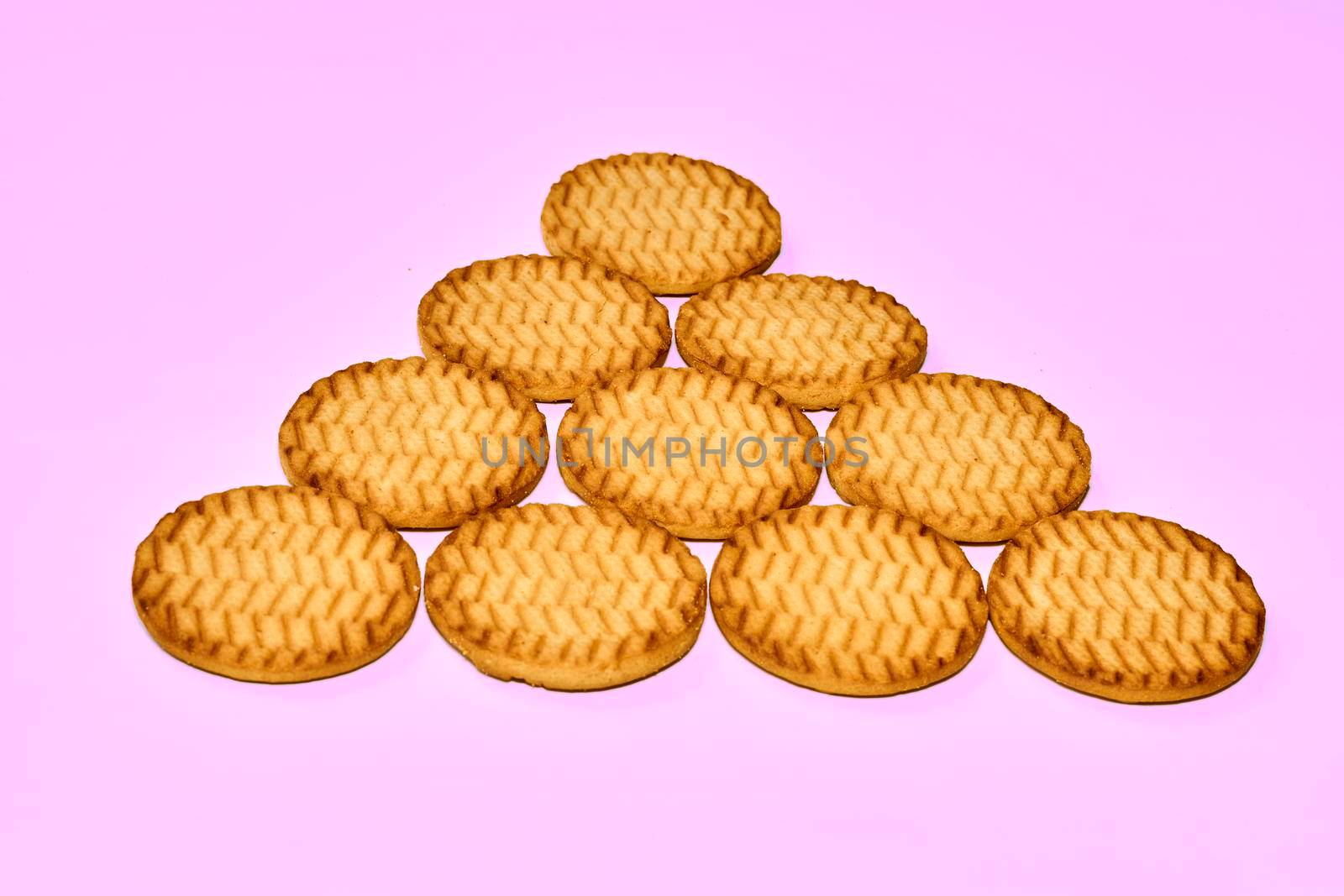 Sweet dessert cookies crekers triangle are a tasty product.Isolated on pink by jovani68