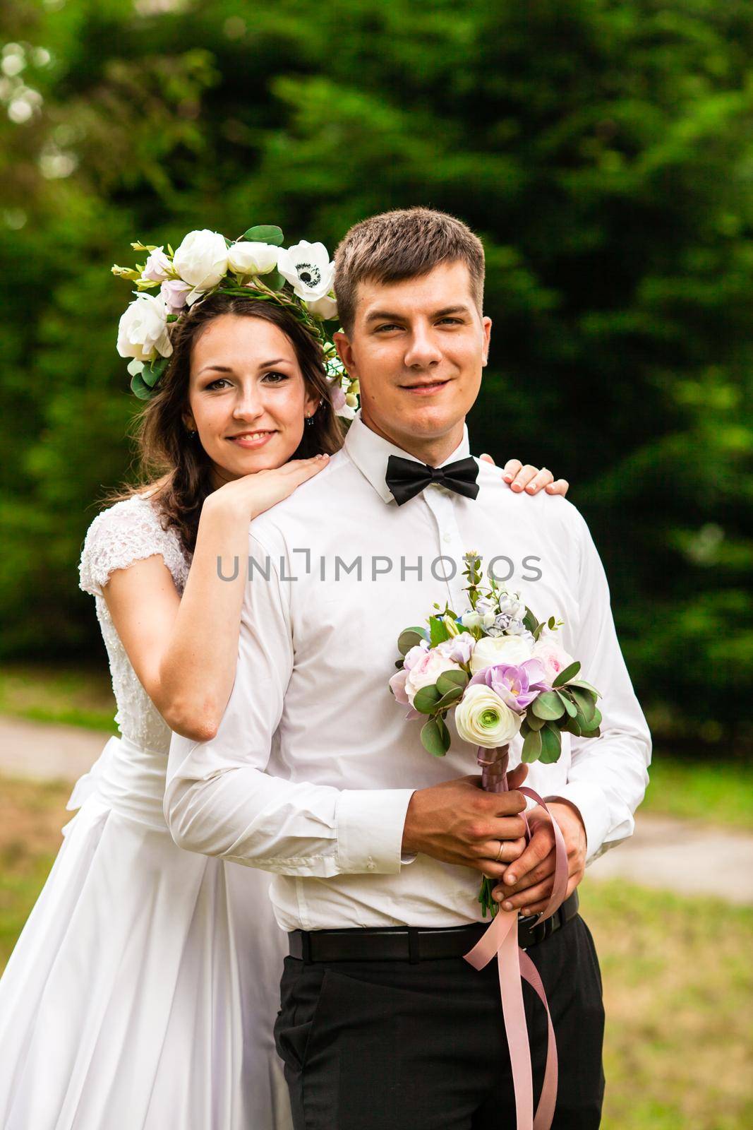 Happy bride and groom after wedding ceremony walking at the park and have photoshoot