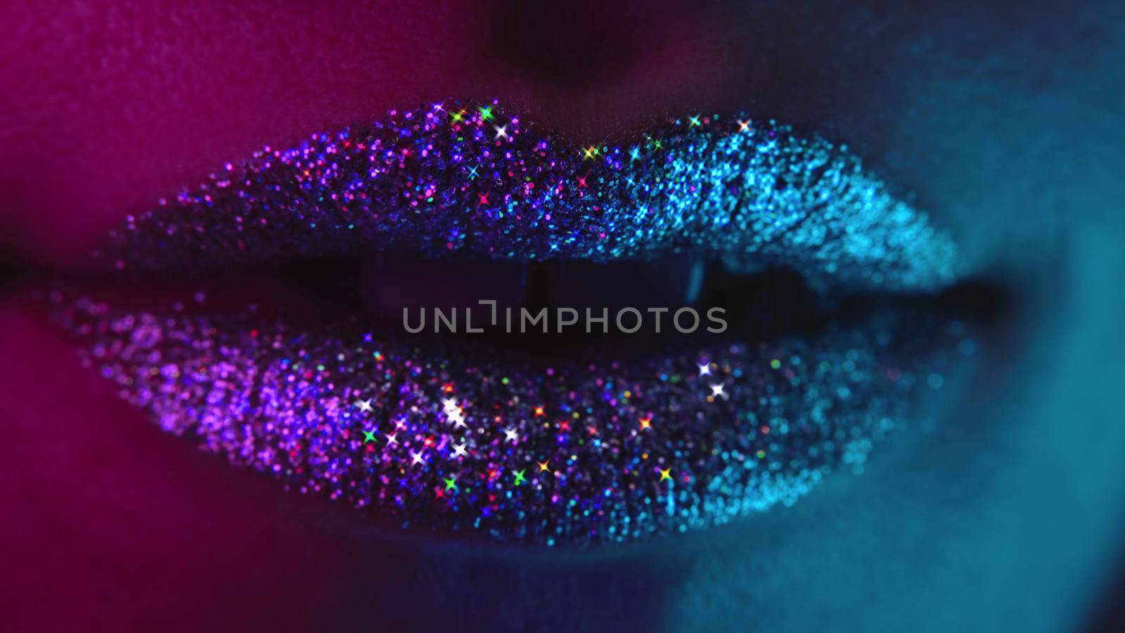 Fashion model with bright shiny sparkles on plump lips. Macro view of woman with glamorous make-up. Nightlife, night club concept. High quality photo