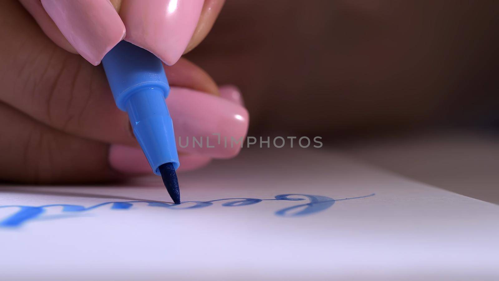 Calligrapher hands writes word beauty on white paper. Inscribing ornamental decorated letters. Calligraphy, graphic design, lettering, handwriting, creation concept. . High quality photo