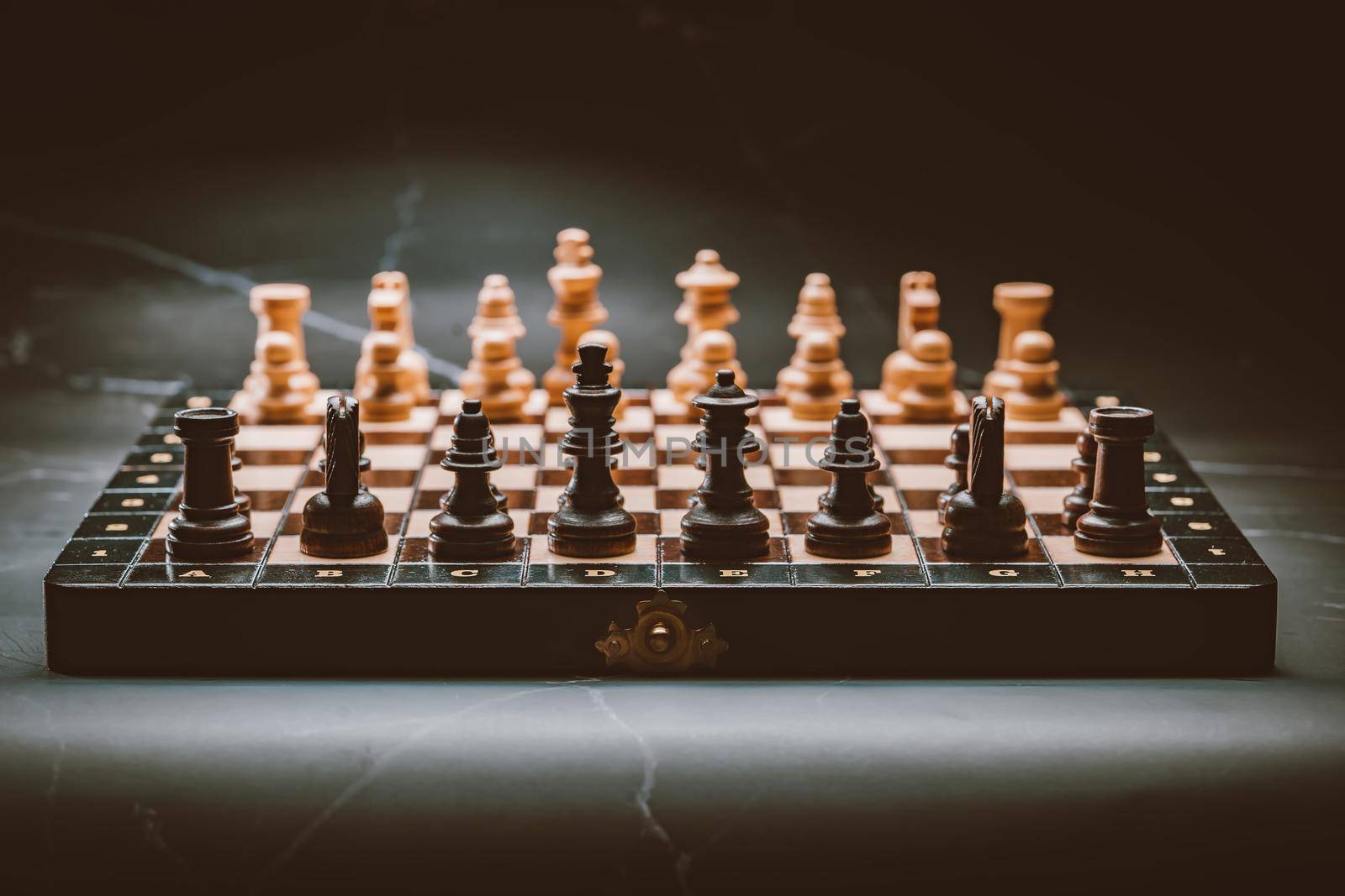 Old vintage chess pieces on wooden chessboard. Board strategy game. Teamwork, success business, intelligence sport concept. by kristina_kokhanova