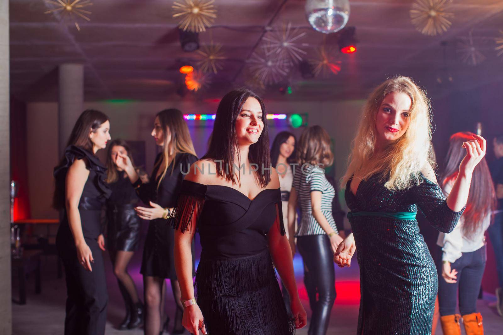Group of dancing women enjoying night in club