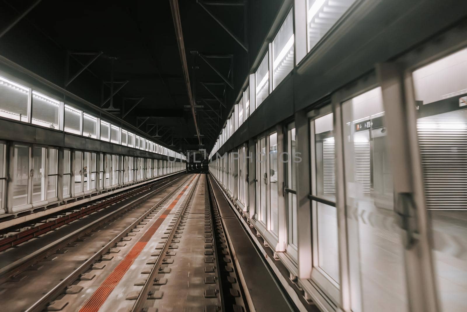 Moving unmanned subway - automatic metro station in Paris. Riding underground train in modern city. Modern public mode of transport. High quality photo