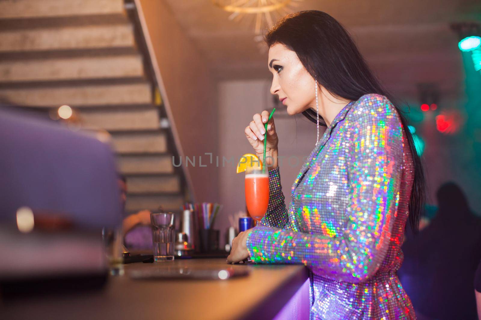 Woman with cocktail drink in the bar by oksix