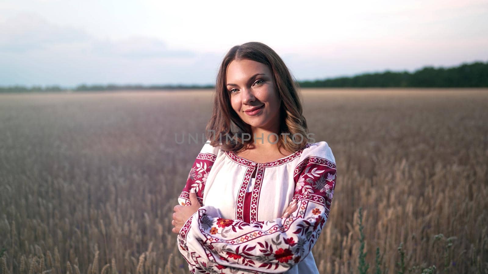 Smiling ukrainian woman in yellow ripe wheat field. Young lady in traditional embroidery vyshyvanka. Ukraine, independence, freedom, patriot symbol, victory in war. High quality photo