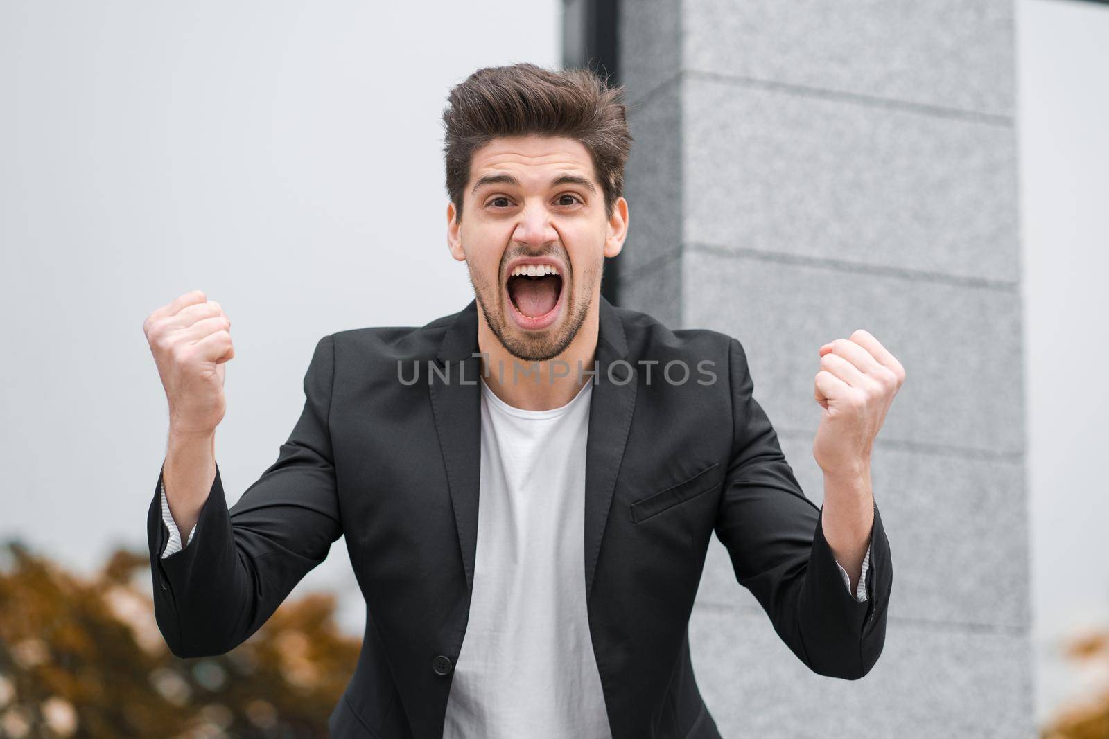 Portrait of angry furious businessman, having nervous breakdown at work, screaming in anger, stress management, mental distress problems, losing temper, reaction on failure. High quality photo