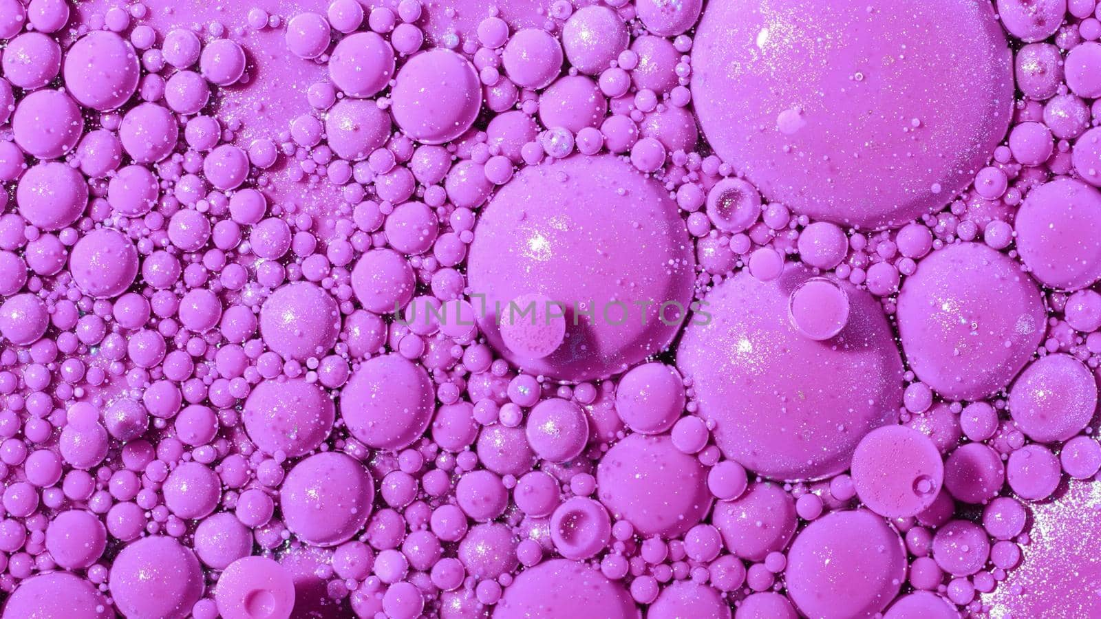 Top view abstract of pink bubbles in paint. Inks, spheres, oil. Colorful shapes. Detailed background, beautiful design, balloons texture. High quality photo
