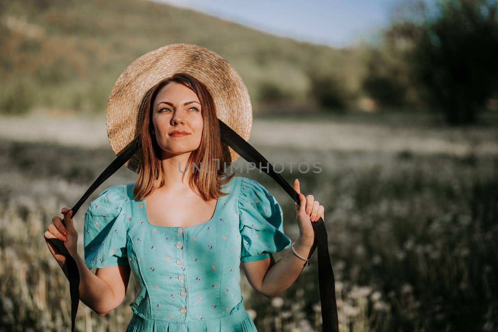 Retro styled woman on fluffy dandelions field, amazing fantasy portrait. Romantic elegant lady with straw hat on nature. Vintage aesthetic lifestyle, floral background. High quality photo