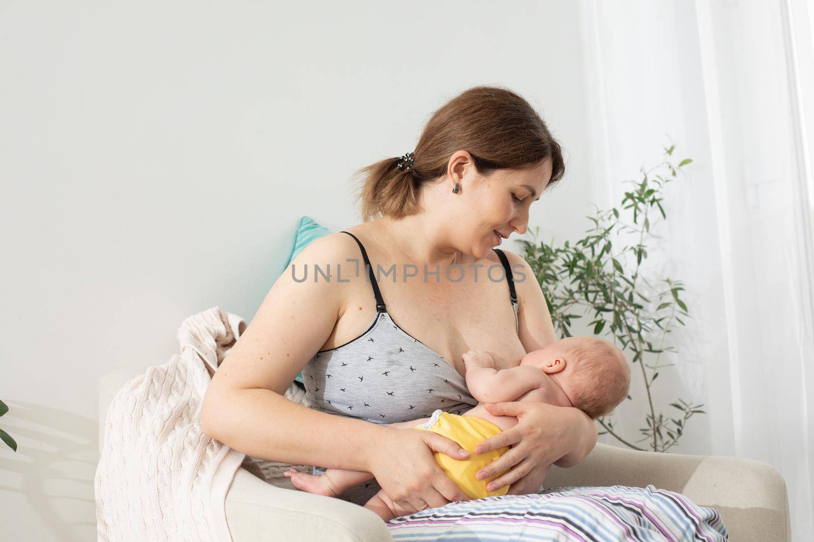 The young mom wants to breastfeed her newborn baby by oksix