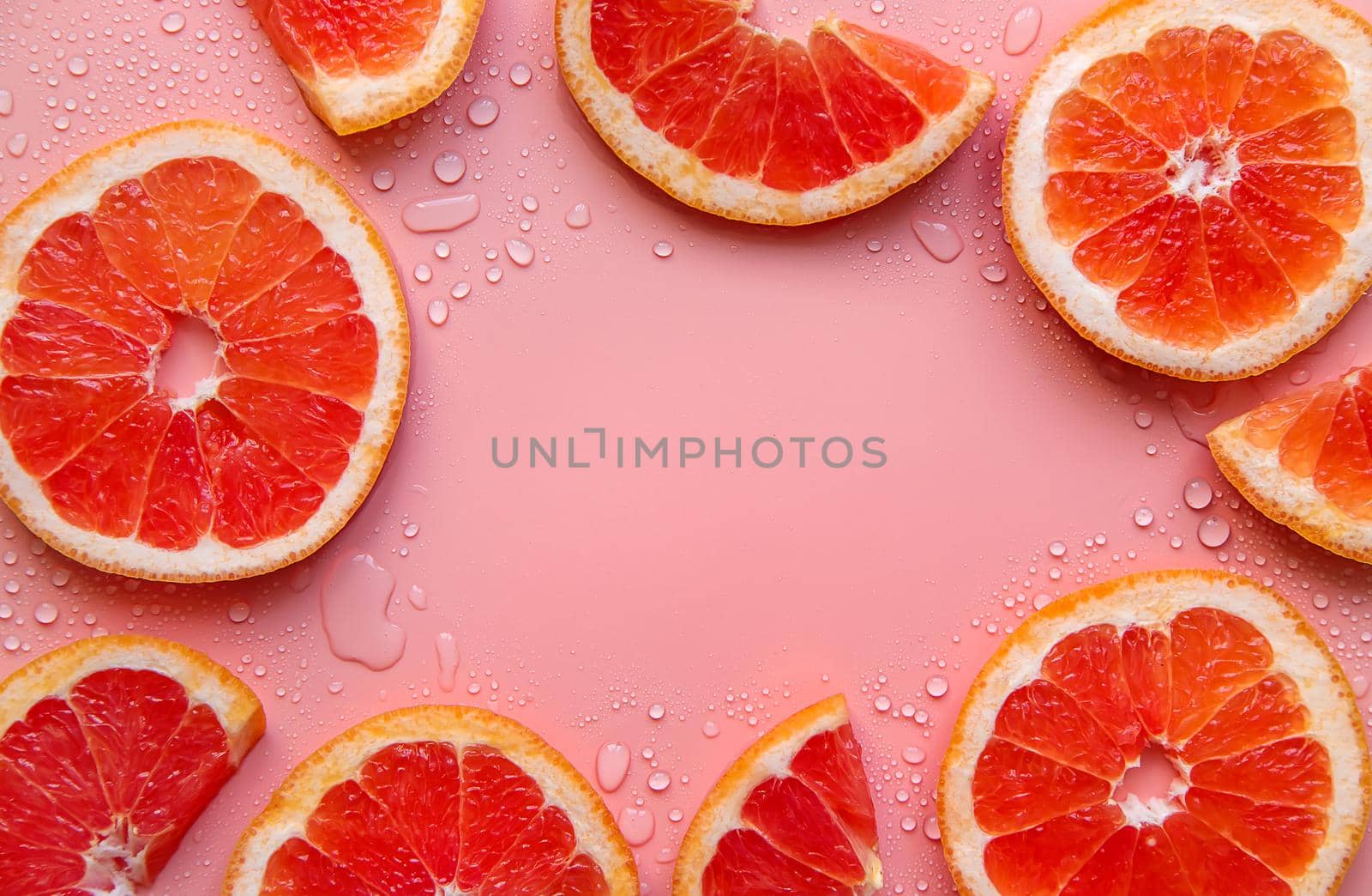 Background with grapefruit and water drops. Selective focus. by yanadjana