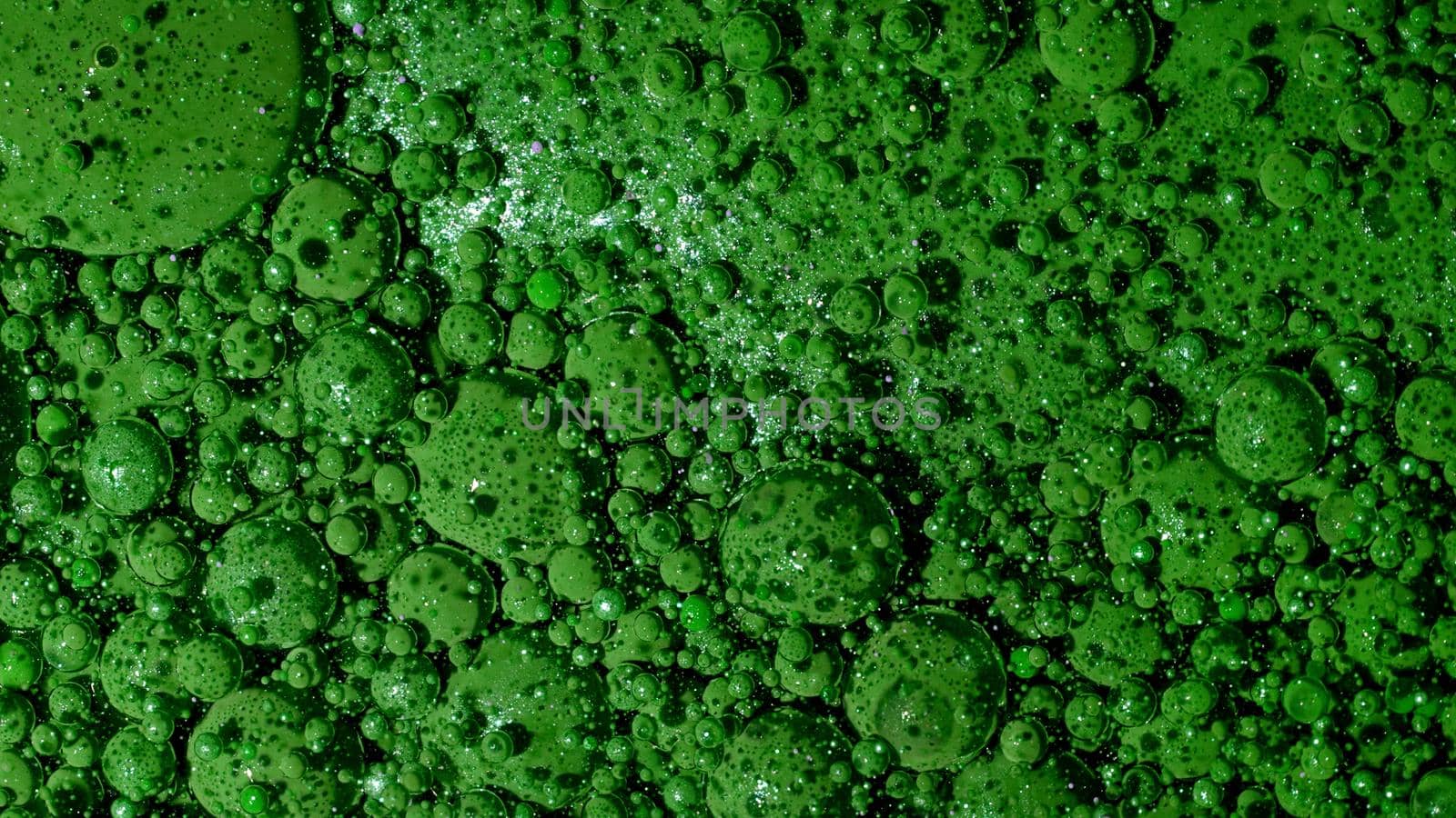 Top view abstract of green bubbles in paint. Inks, spheres, oil. Colorful shapes. Detailed background, beautiful design, balloons texture. High quality photo